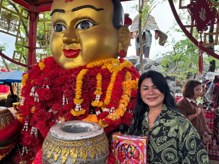 หญิงสาวกำลังไหว้ขอพรและแก้บนกุมารทองเจ้าสัวเฮงที่อาศรมฤๅษีเณร